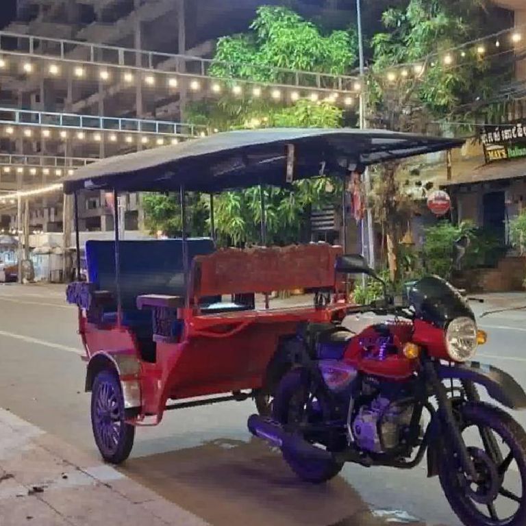 Guests riding in a Kampot tuktuk